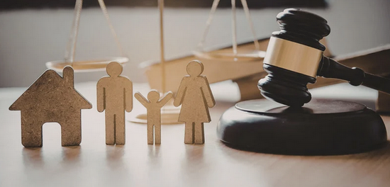 Wooden houses sit next to a gavel