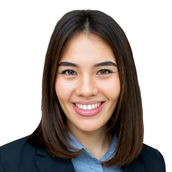 White woman in blue blazer smiling