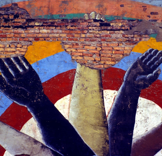 A mural of raised hands of different races
