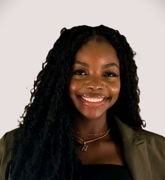 Black woman with dark green coat smiles
